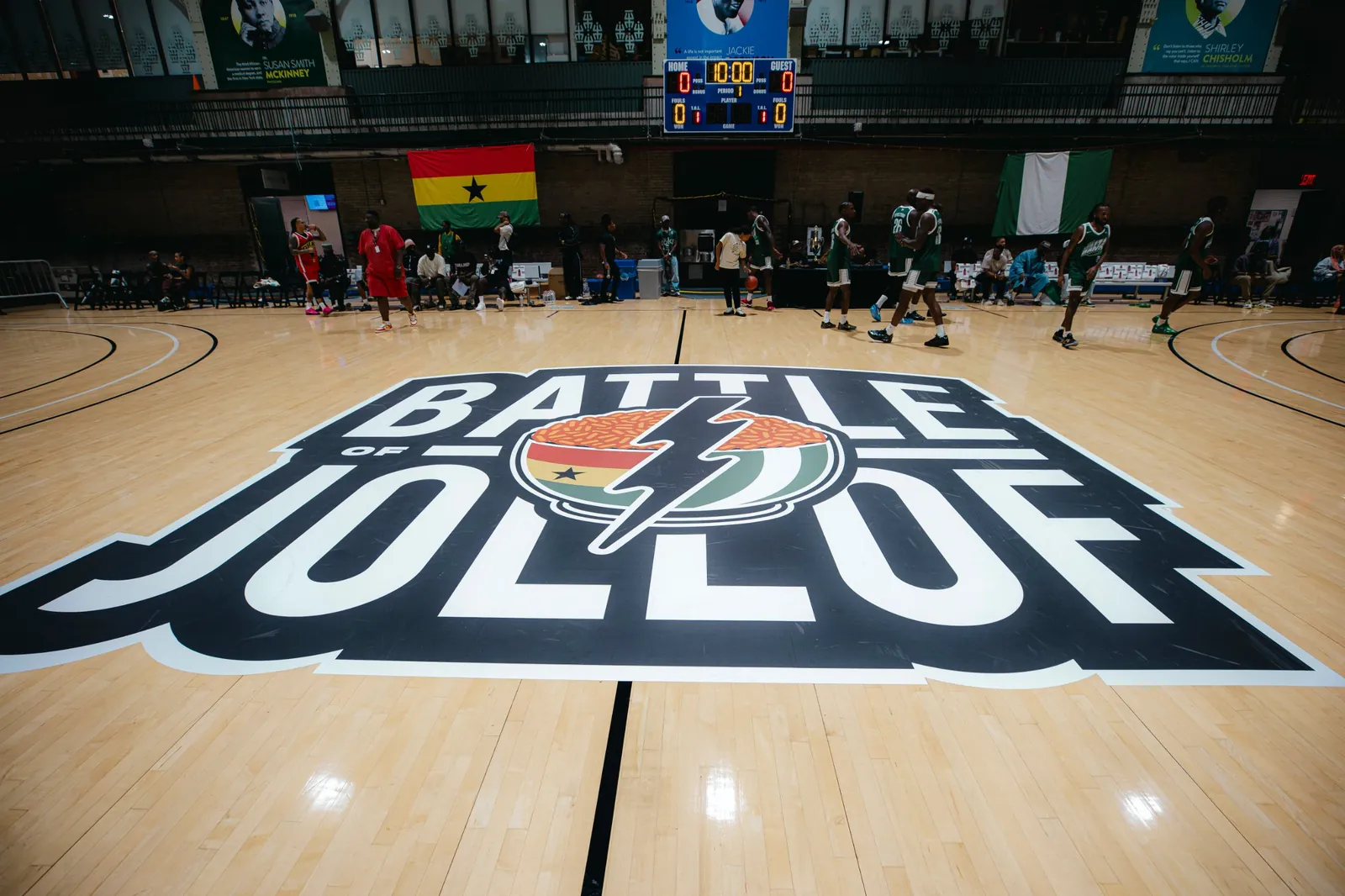 The Battle of Jollof logo painted at center court, with Ghana and Nigeria flags on the wall