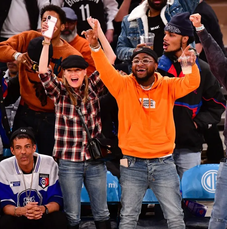Davido cheering courtside at a Knicks game